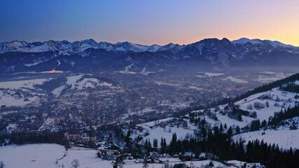 Wall Mural - Snowy zakopane in winter after dusk, aerial view