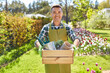 © Syda Productions - gardening and people concept - happy smiling middle-aged man in apron with tools in box at summer garden