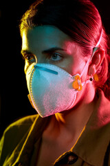 Poster - health, safety and pandemic concept - close up of young woman wearing protective mask or respirator over black background