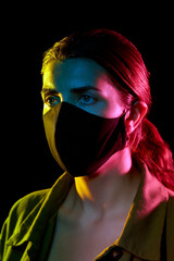 Poster - health, safety and pandemic concept - young woman wearing reusable protective mask over black background