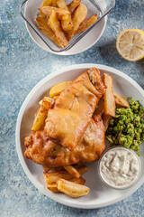 Wall Mural - Fish in beer batter and chips with green pea and tartar sauce