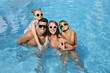 © New Africa - Happy family in outdoor swimming pool on sunny summer day