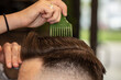 © marcinmaslowski - barber working on his client's haircut