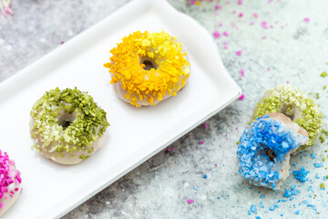 Closeup shot of tabletop of vegan raw colorful donuts