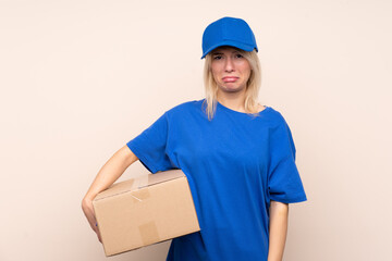 Young delivery woman over isolated background sad