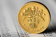 One pound coin on a summary table