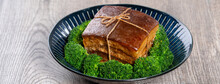 Dong Po Rou (Dongpo Pork Meat) In A Plate With Green Vegetable, Traditional Festive Food For Chinese Lunar New Year Cuisine Meal, Close Up.