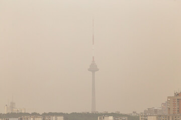  A cityscape that is covered by smog that is caused by pollution, Vilnius TV tower, Lithuania