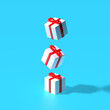 © Katya Havok - 3d render. Xmas gift boxes flying above blue pastel background. Winter holidays concept. Surreal art.