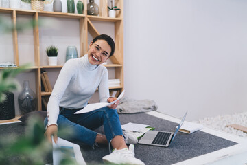 Canvas Print - Optimistic woman working with papers at home