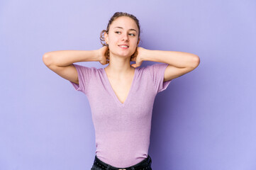 Wall Mural - Young caucasian woman on purple background feeling confident, with hands behind the head.