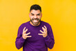 © Asier - Young mixed race arabic man isolated upset screaming with tense hands.