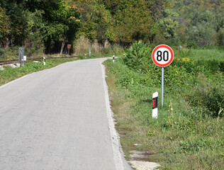 Road sign that warns drivers that maximum speed is 80 kilometers per hour