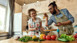 © Svitlana - Italian man adding pepper, spice to the soup while woman holding a spoon, smiling at camera. Couple preparing a meal together in the kitchen. Cooking at home, Italian cuisine