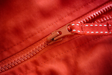 Wall Mural - Closeup shot of a zipper on a red jacket