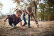 © luckybusiness - Brother and sister playing in the woods; Healthy childhood concept