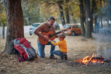 Wall Mural - Grandfather and grandson singing together; Quality family time concept