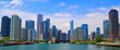 © MediaGio Photography - View of Chicago Skyline from Lake Michigan on a partly cloudy blue sky day.