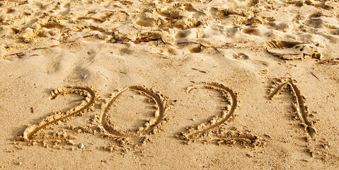 Happy new year 2021 text on the sea beach. Abstract background photo of the upcoming new year 2021