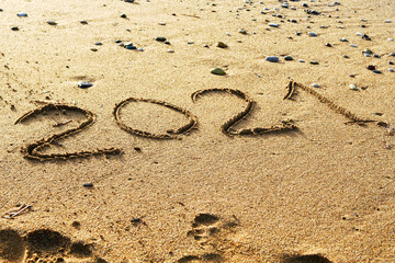 Happy new year 2021 text on the sea beach. Abstract background photo of the upcoming new year 2021