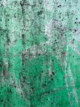 Close Up Of Green Peeling Paint And Graffiti On Metal Wall