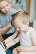 © Amir KaljikoviÔøΩÔøΩ Photography/Stocksy - Happy little blond boy having a haircut