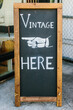 © Kristen Curette Photography LLC/Stocksy - A chalkboard stand with ''vintage Here'' drawn on it.