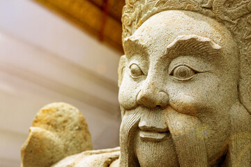 stone sculpture of a warrior adorns the temple of asia close up