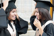 © Per Swantesson/Stocksy - Friends fixing graduation hat before ceremony