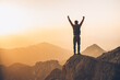 © Micky Wiswedel/Stocksy - Hiker on a desert mountain summit at sunset