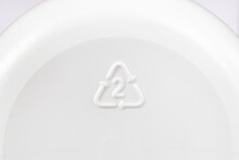 A Triangle Recycling Icon With Number 2 Seen On The Bottom Of A Plastic Bottle Indicating It's Made Of High-density Polyethylene, Or HDPE, A Recyclable Plastic Material And Safe For Reuse. Macro View.