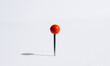 © Lucas Saugen Photography/Stocksy - A red push pin casting a shadow.