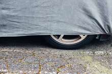 Detail Of Car-cover Fabric Over Parked Automobile