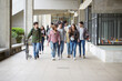 © MIQUEL LLONCH/Stocksy - Group of young students walking towards de camera in the campus