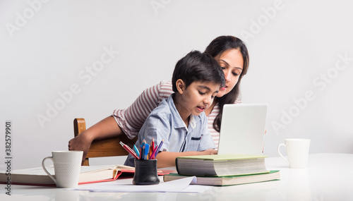 Online school in India concept - Cute little son taking mother\'s help in studies or homework