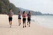 © Jovo Jovanovic/Stocksy - Group of friends running together at the beach