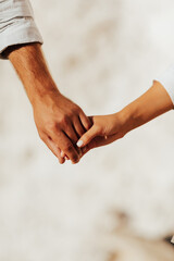 Couple on summer sunny day. Woman and man holding hands. Close up of a couple holding hands.