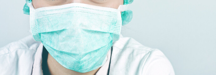 Woman doctor wearing a medical protective mask against coronavir