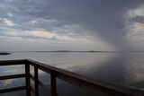 Fototapeta Na sufit - beautiful evening on the lake. wooden bridge, beautiful sky and calm water