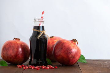 Wall Mural - Fresh ripe pomegranate and juice in a bottle. Close up