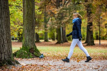 Wall Mural - middle-aged woman walking in city park