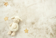Toy Lamb And Wooden Stars On Pastel Background. Motherhood Concept. Top View, Flat Lay Composition. Copy Space For Text.