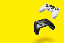 White And Black Game Controllers On Yellow Background