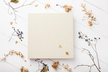 Elegant Beige Book With Linen Cover On White Wooden Background. Wedding Photobook. Wedding Photo Album With Autumn Dried Leaves And Plants. School And Autumn Background. Fall Mock Up. Thanksgiving Day