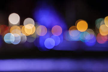 Wall Mural - Golden and purple Bokeh background. Defocused of night cityscape and street. Abstract blurry background of glitter light.