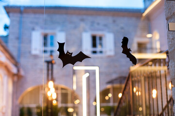 Happy Halloween. Decorations for night party and celebration in italian house. Bats on windows and front door of restaurant and hotel.