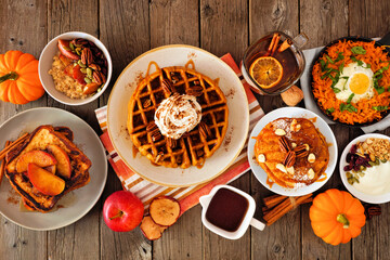 Aufkleber - Fall breakfast or brunch buffet table scene against a dark wood background. Pumpkin spice, waffles, pancakes, apple french toast, oatmeal, egg skillet, yogurt. Top down view.
