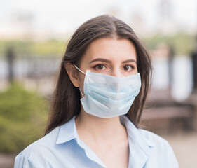 Portrait of a young and beautiful girl in a medical mask. Health care