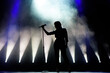 © nagaets - Vocalist singing to microphone. Singer in silhouette