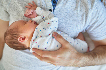 Wall Mural - Newborn baby girl sleeping on her father's chest